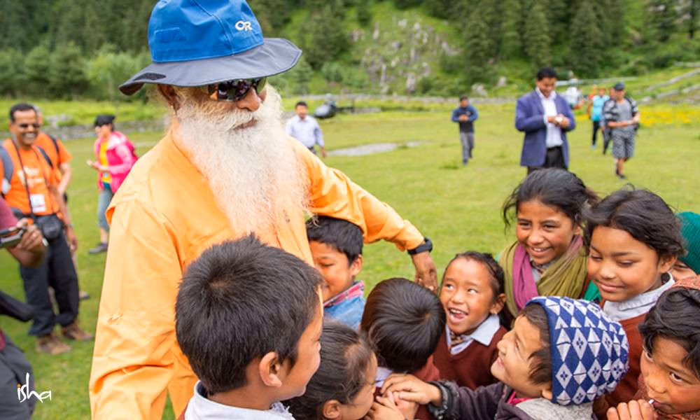 Children gathered around Sadhguru outdoors
